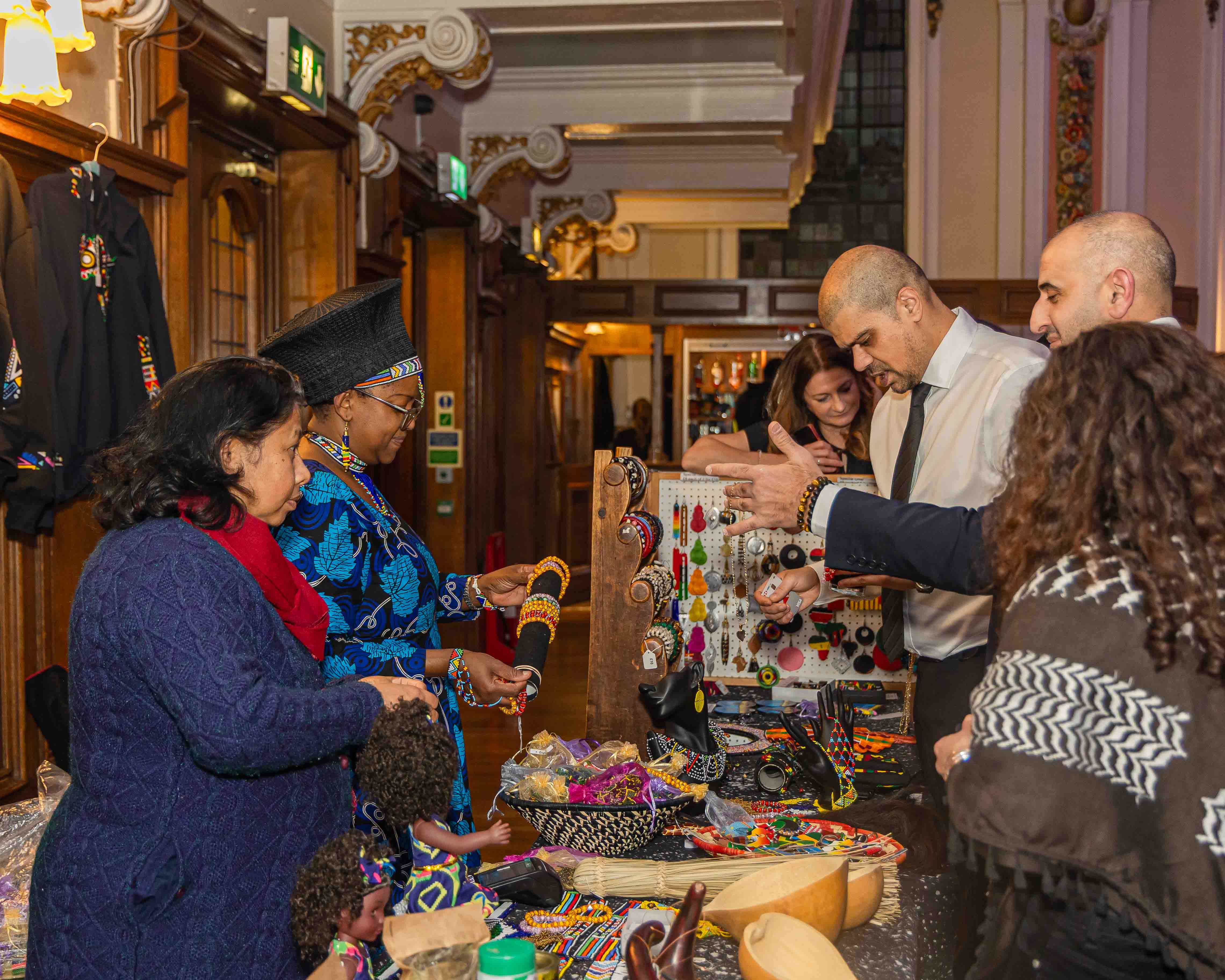 Guests browsing a community craft and culture stall at the gala